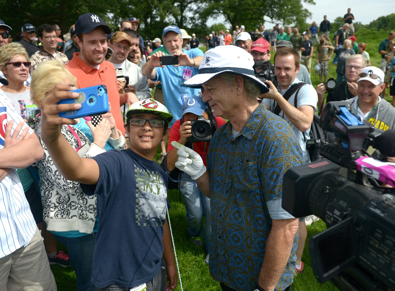 Actor Bill Murray tells Elijah Turner, of Riverdale Iowa, the correct way to ask for a "selfie" in between the 4th and 5th holes during the John Deere Classic Pro-Am Wednesday, July 8, 2015, in Silvis. (Photo by Todd Mizener - Dispatch/Argus)