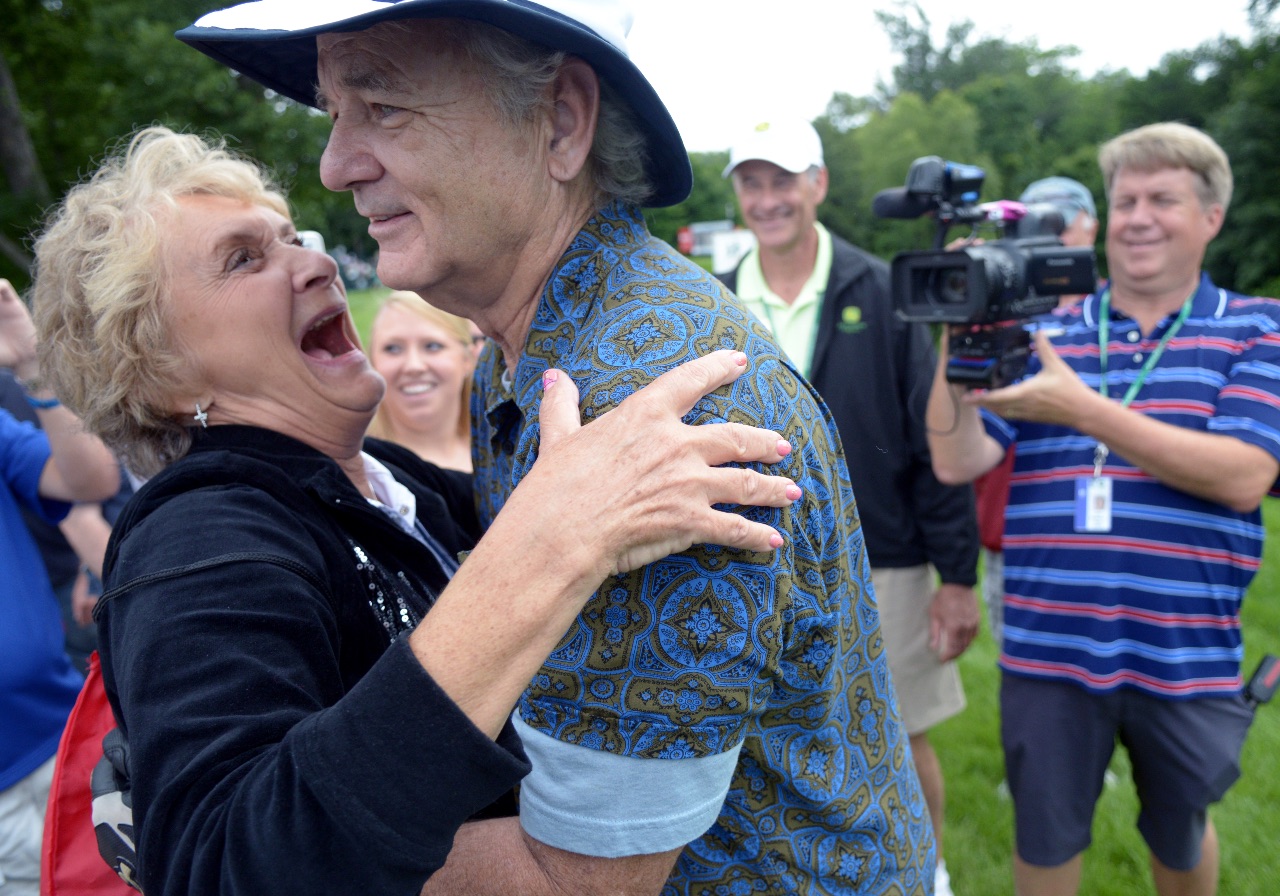 Actor Bill Murray gets a big hug from Mary Jo Points, the mother of PGA pro D.A. Points, along the 5th fairway during the John Deere Classic Pro-Am, Wednesday July 8, 2015. (Photo by Todd Mizener - Dispatch/Argus)