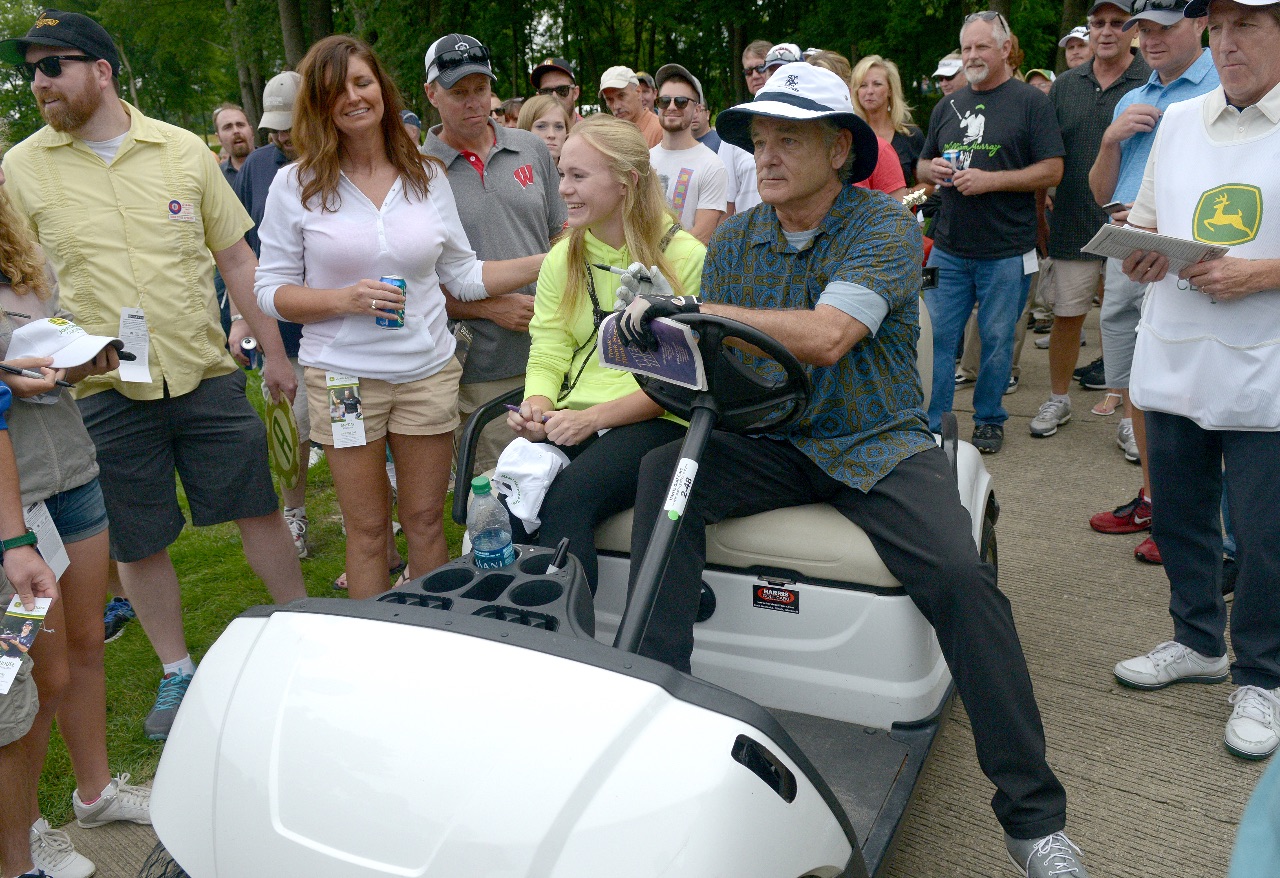 Actor Bill Murray gives Lucie Dierikx, of Taylor Ridge, a rise in his golf cart during the John Deere Classic Pro-Am Wednesday July 8, 2015. (Photo by Todd Mizener - Dispatch/Argus)
