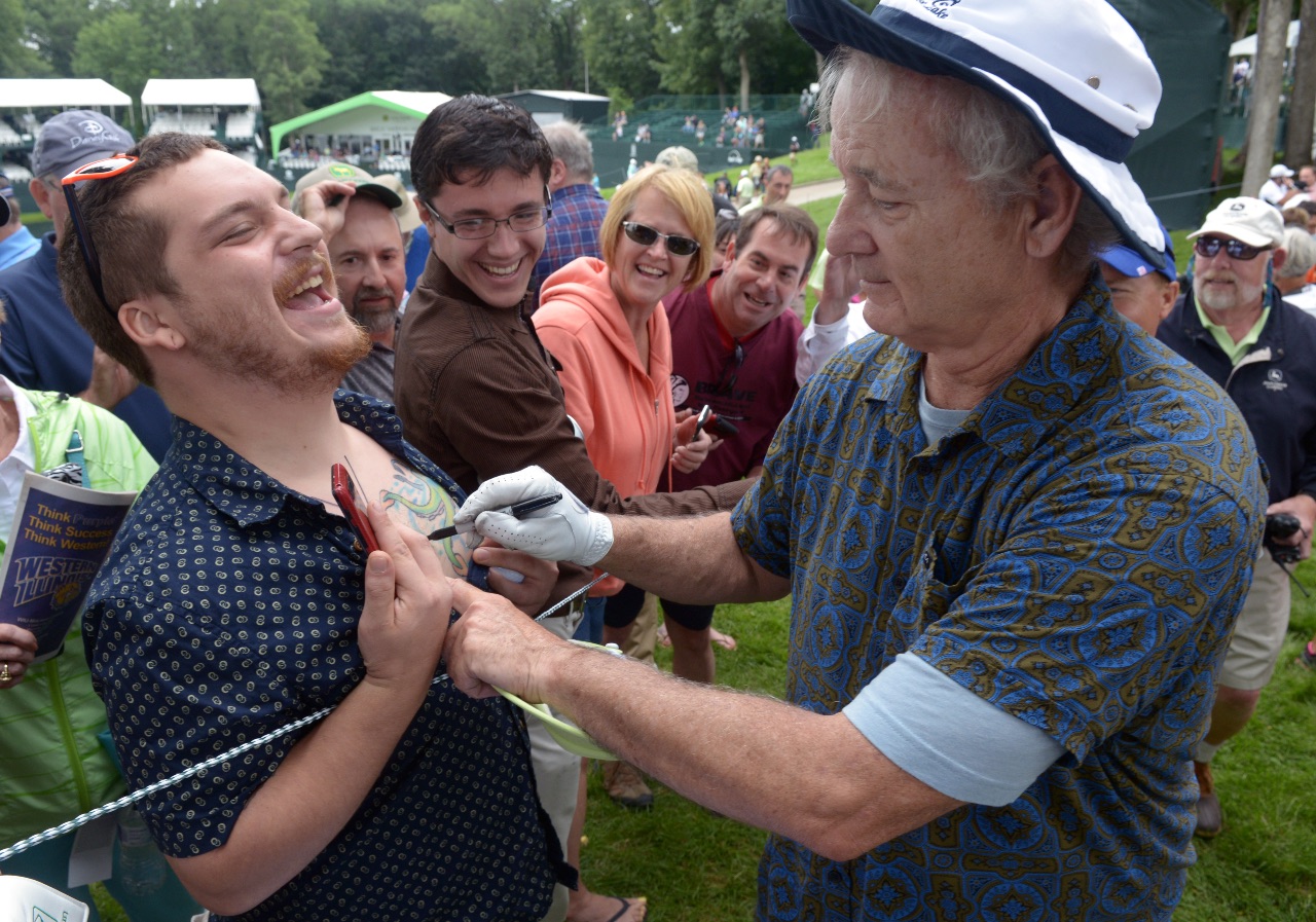 Actor Bill Murray signs an autograph on the chest of a fan after playing in the John Deere Classic Pro Am on Wednesday, July 8, 2015, in Silvis. The Oscar-nominated actor drew a huge crowd to the event and was very generous with his time, signing autographs and posing for photos in between holes. (Photo by Todd Mizener - Dispatch/Argus)