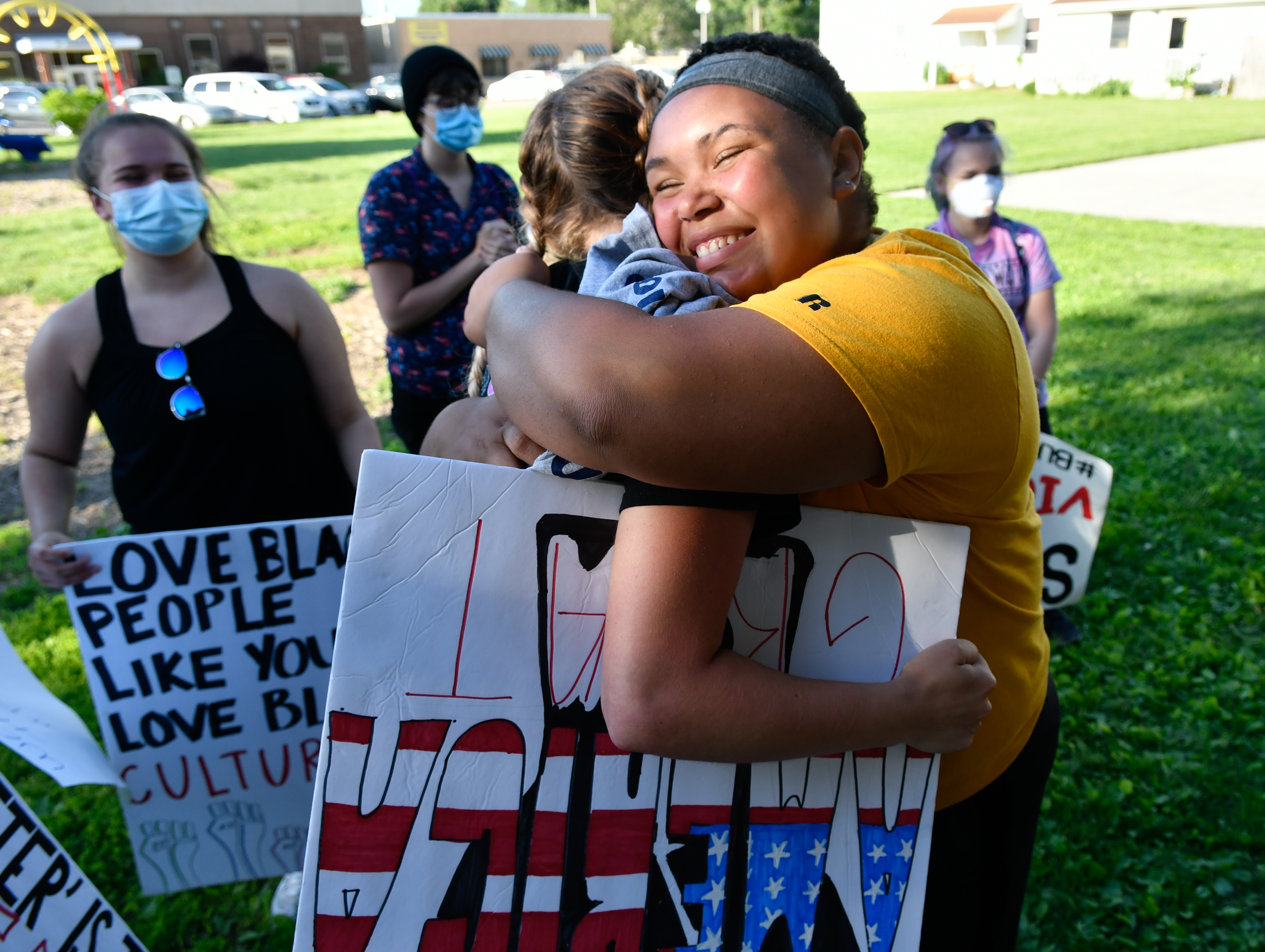 Iliawna Hook, 16, a junior at nearby Mercer County High School, receives a hug from a white classmate after Hook spoke to the crowd during Thursday’s  Black Lives Matter protest about being called the N-word at school sporting events. 