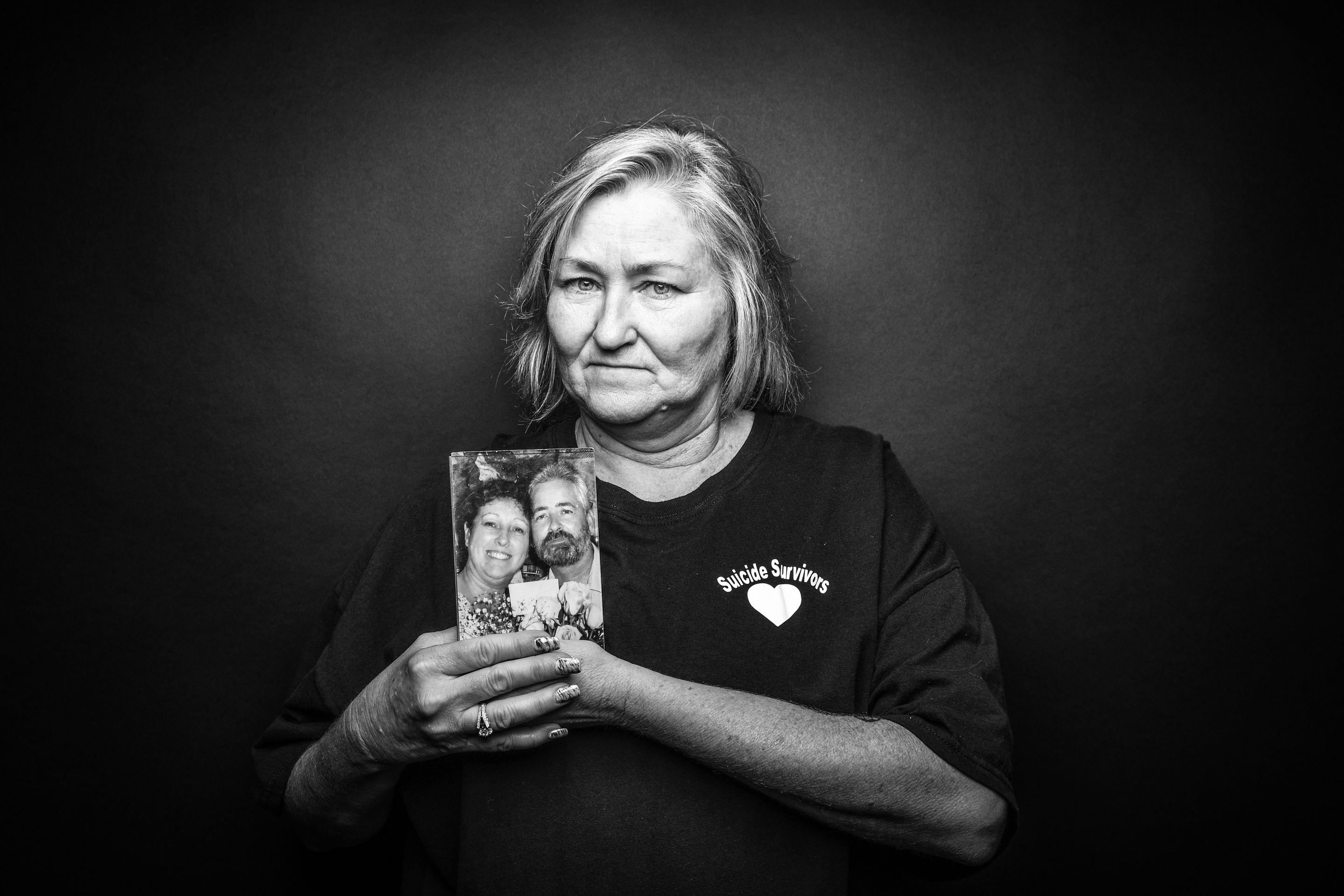 Cheri Jenkins, East Moline, holds a photo of her mother and stepfather, who died by suicide in Florida, within two weeks of each other in 2011.