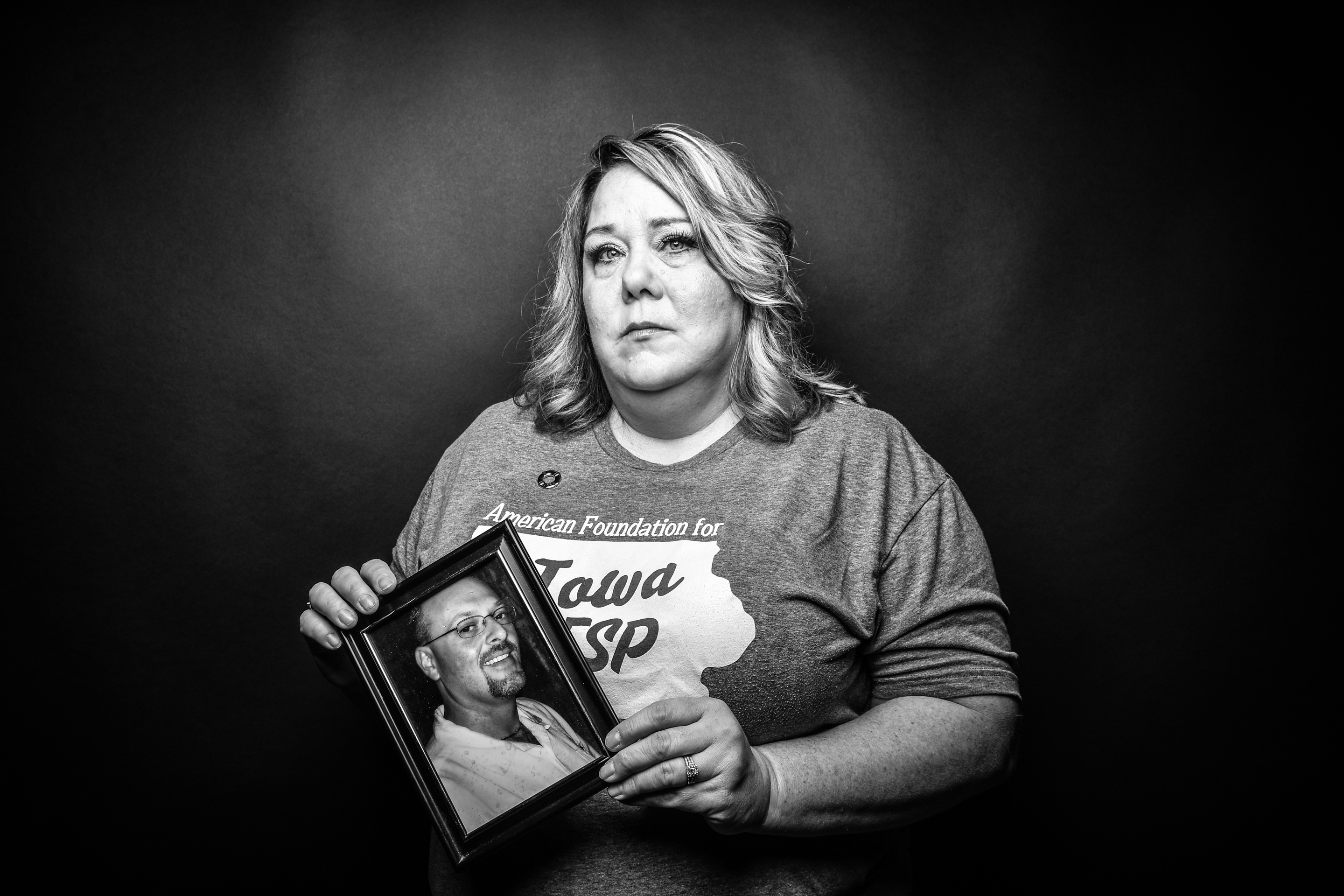 Christina Malchodi, Bettendorf, holds a photo of her former fiance, Rich, who died by suicide at 37, in 2010.