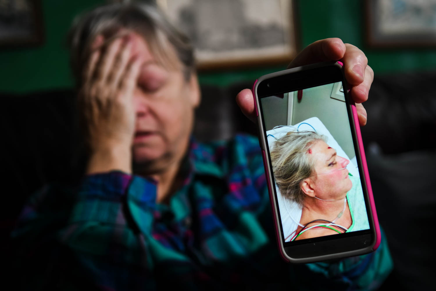 Dee Robbins, of Rock Island, is overcome by emotion on Thursday while holding up a photograph of Kevin Parker, her longtime boyfriend, lying in the hospital after he was the victim of an intentional hit-and-run accident. Mr. Parker sustained a collapsed right lung, bleeding on the brain, mutiple rib fractures, and a fractured spine. He also suffered memory loss. 