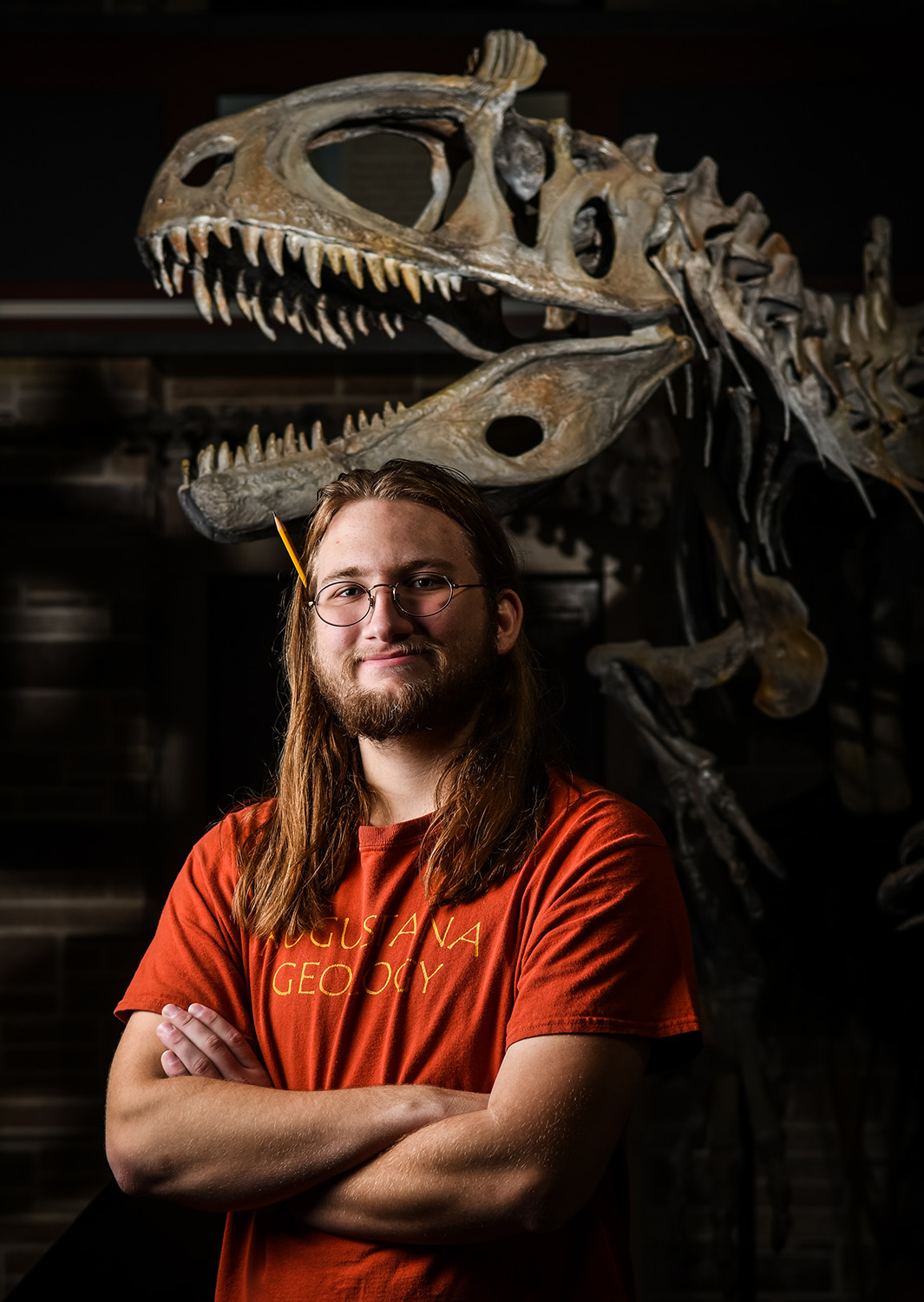 Augustana College student Quinton Powers poses for a portrait in the college's Fryxell Geology Museum. The Eagle Scout, from Homer, Ill., discovered a new stegosaurus bone during a paleontology dig about 100 miles from Billings during his summer internship at the Judith River Dinosaur Institute in Montana. 
